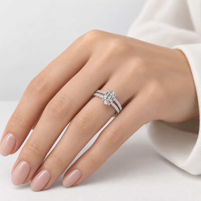 Oval diamond engagement ring with pavé split shank and claw-set centre stone