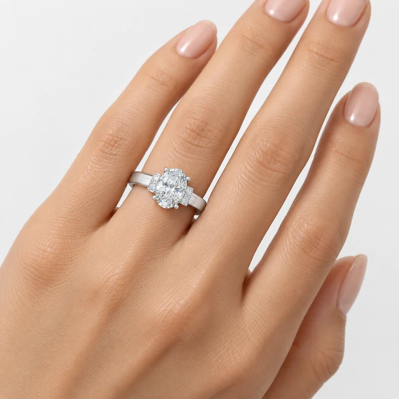 Oval diamond engagement ring featuring accent side stones