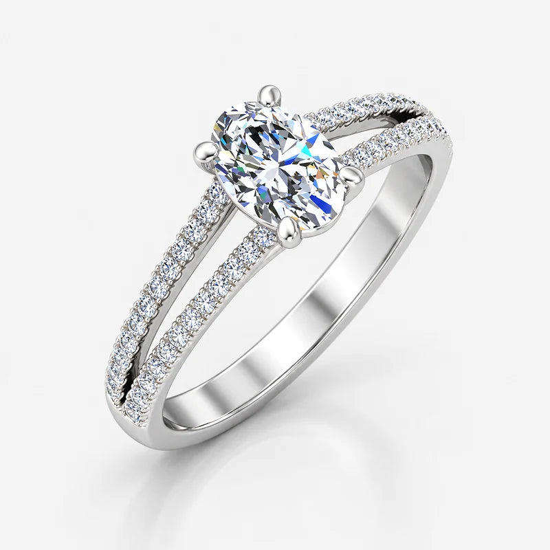 Oval-cut diamond claw engagement ring with pavé split shank detailing