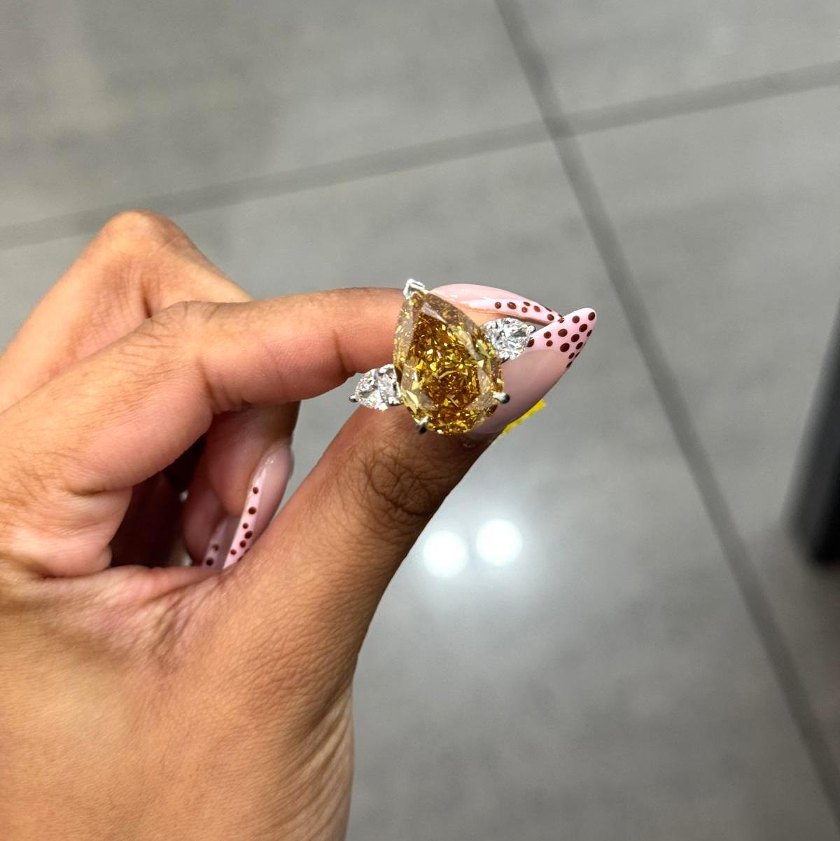 Rare Beauty: Certified 12.50ct Fancy Vivid Brownish Yellow Pear Diamond Trilogy Ring in Platinum