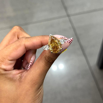 Rare Beauty: Certified 12.50ct Fancy Vivid Brownish Yellow Pear Diamond Trilogy Ring in Platinum