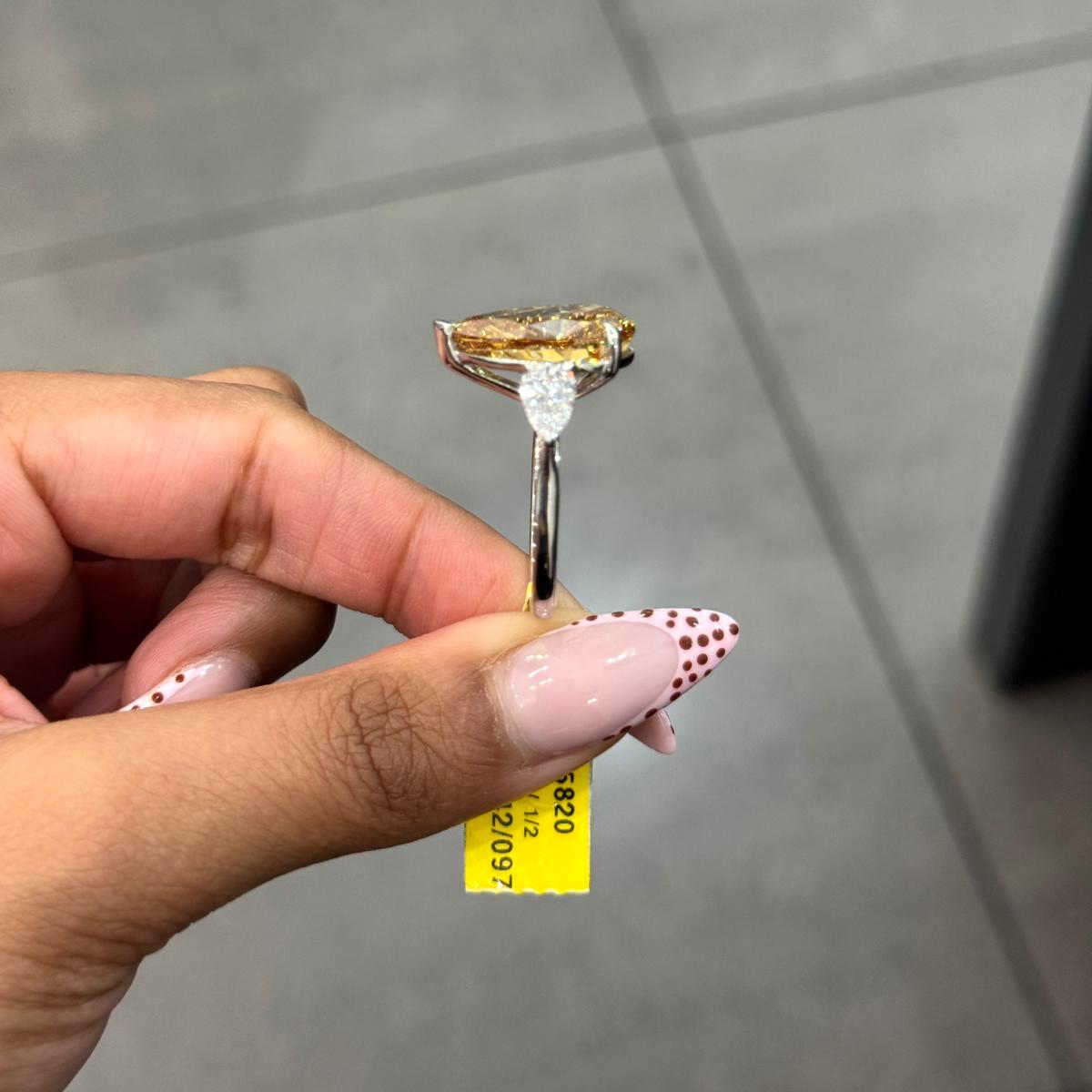 Rare Beauty: Certified 12.50ct Fancy Vivid Brownish Yellow Pear Diamond Trilogy Ring in Platinum