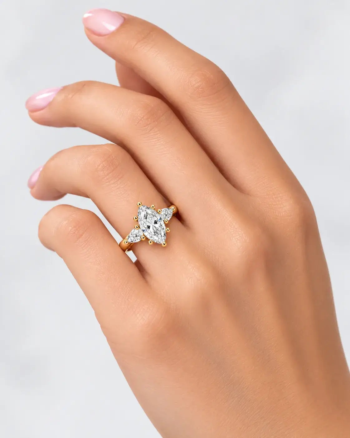 Marquise Diamond with Side Pear Diamond Trilogy Claw Set Engagement Ring in 18K Yellow Gold IGI Lab Grown