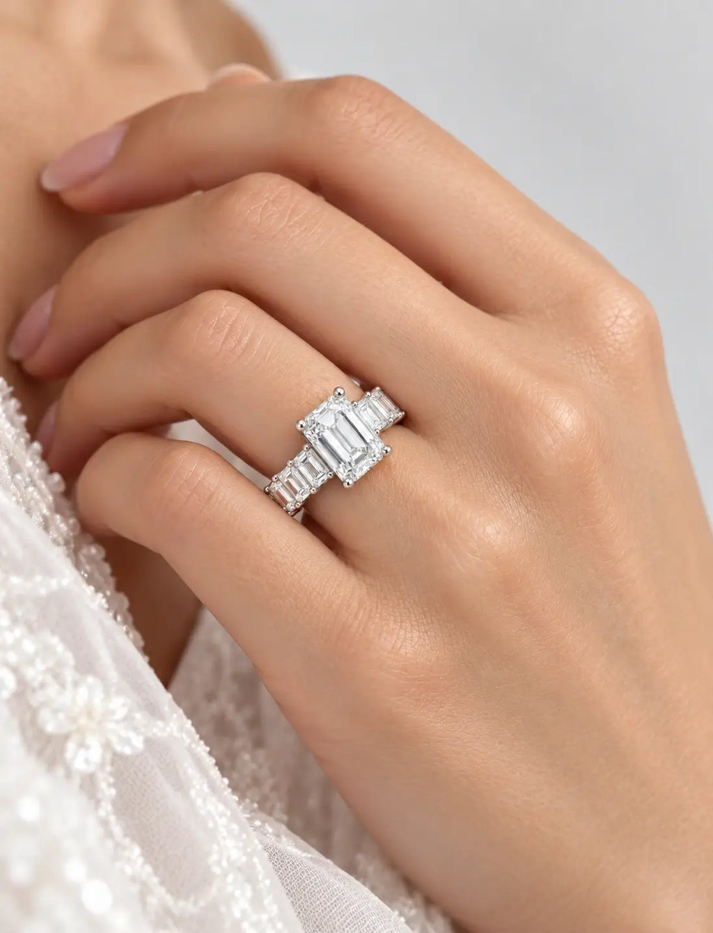 Emerald-Cut Lab Grown Diamond Engagement Ring with Prong-Set IGI Certified Emerald Side Stones in Platinum