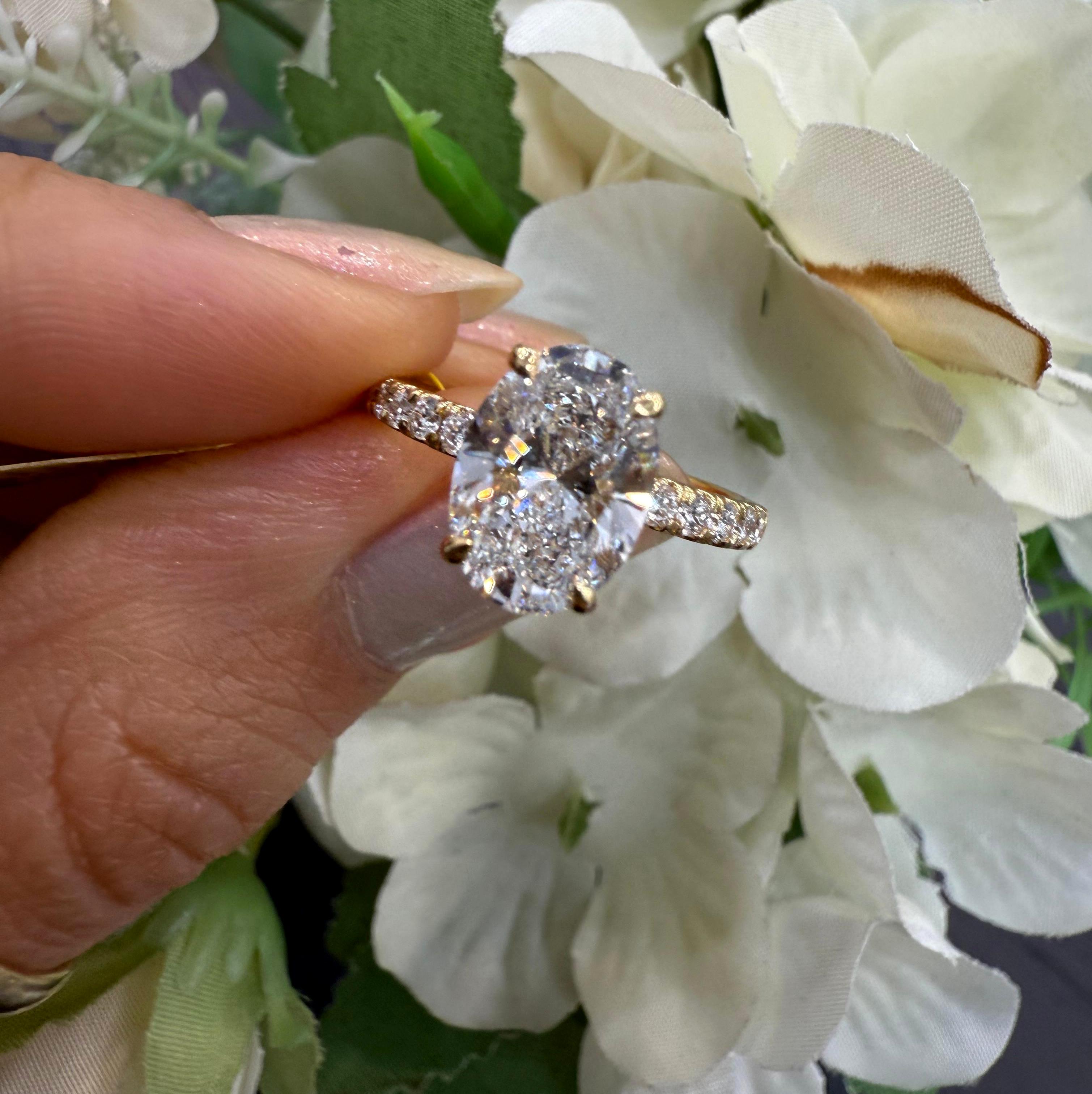 IGI Certified 2.00 Carat E/VS Oval With Side Diamond Hidden Halo Engagement Ring In 18K Yellow Gold