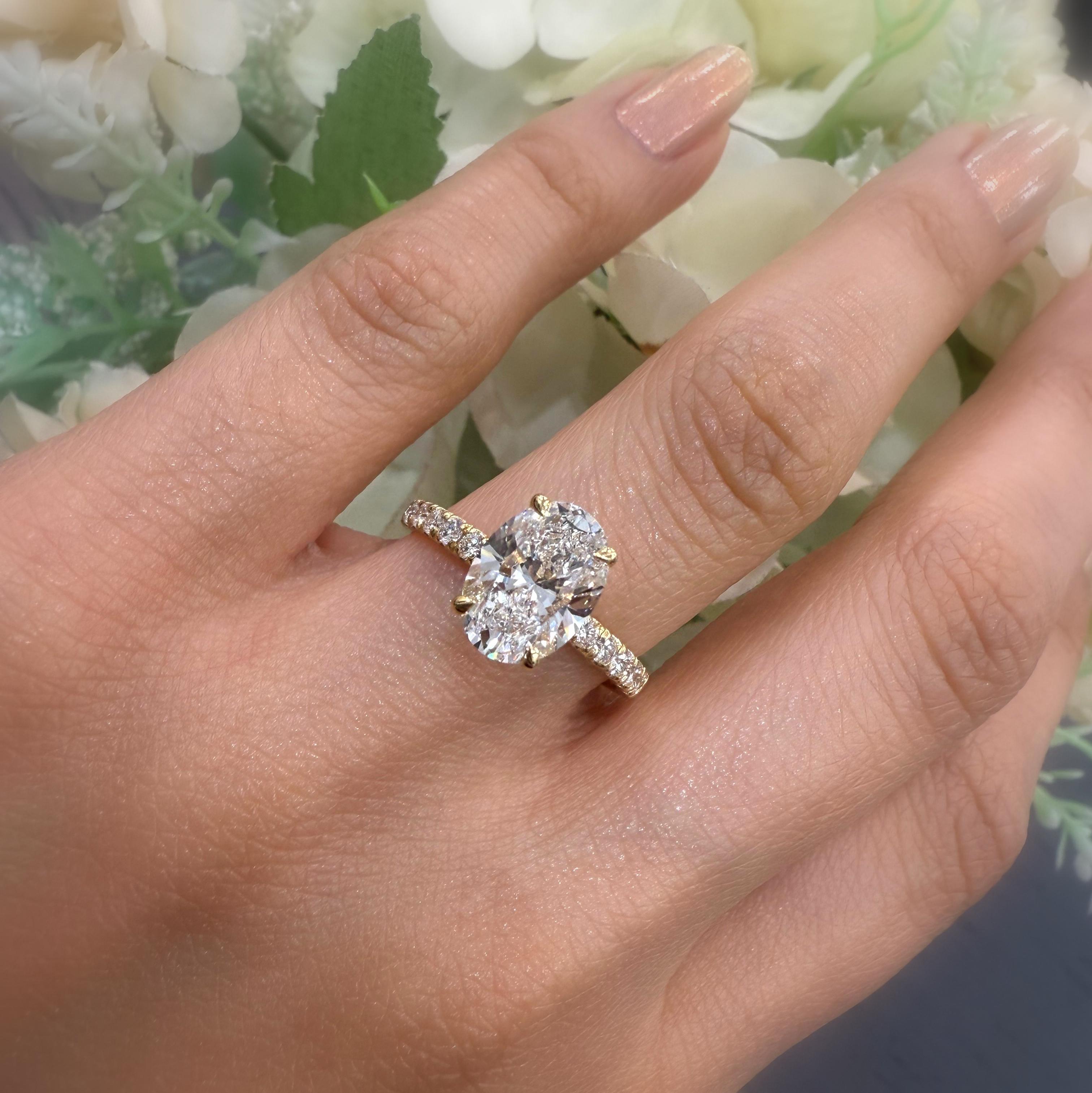 IGI Certified 2.00 Carat E/VS Oval With Side Diamond Hidden Halo Engagement Ring In 18K Yellow Gold