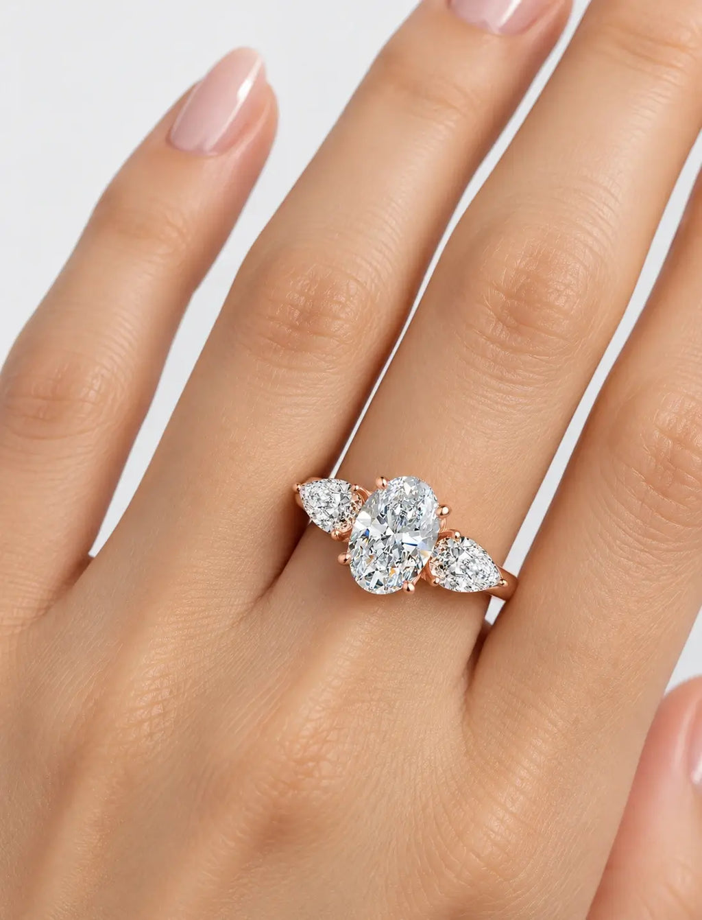 IGI Certified Lab Grown Oval Cut Three-Stone Diamond Engagement Ring with Pear Side Stones in Gold & Platinum