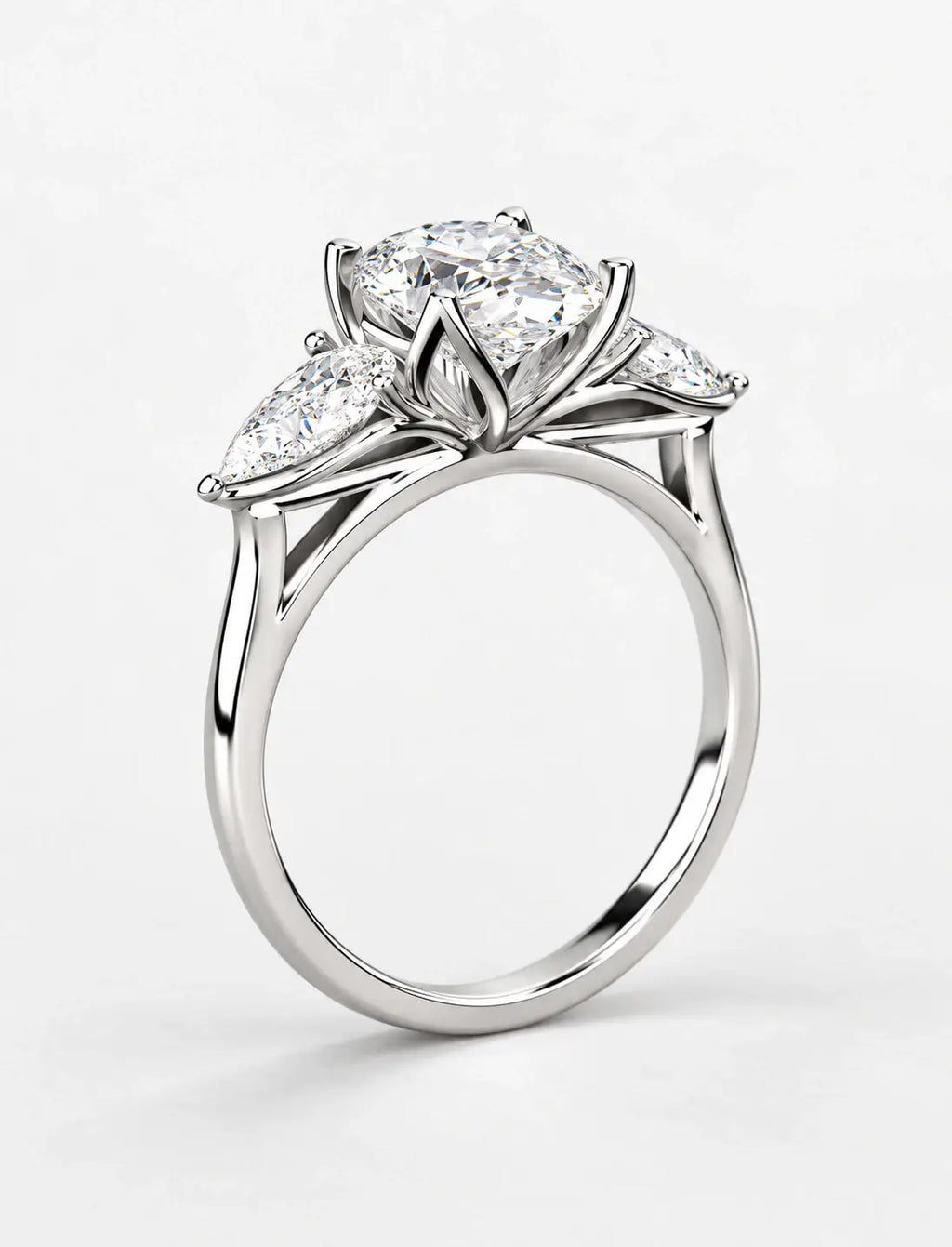 IGI Certified Lab Grown Oval Cut Three-Stone Diamond Engagement Ring with Pear Side Stones in Gold & Platinum