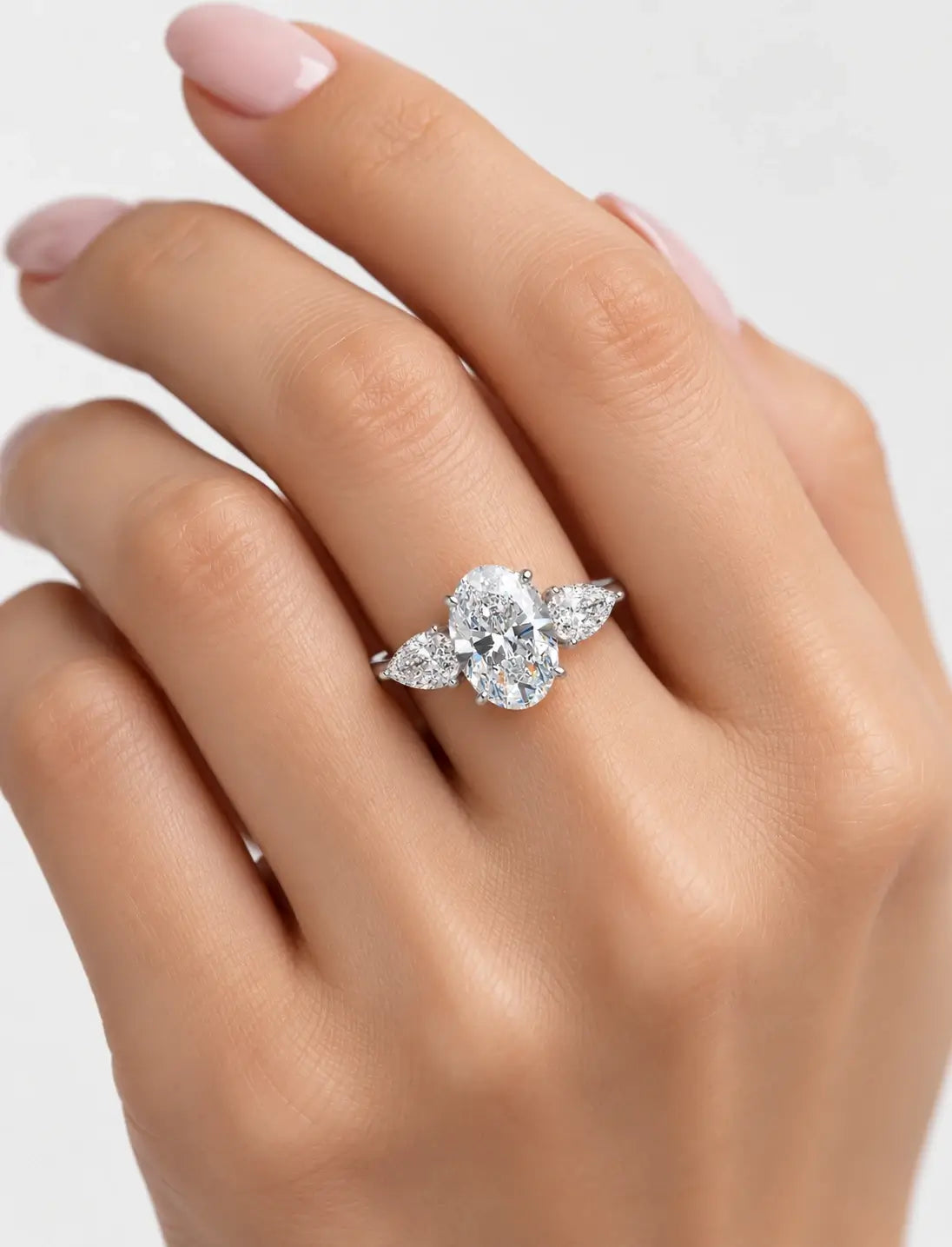 IGI Certified Lab Grown Oval Cut Three-Stone Diamond Engagement Ring with Pear Side Stones in Gold & Platinum