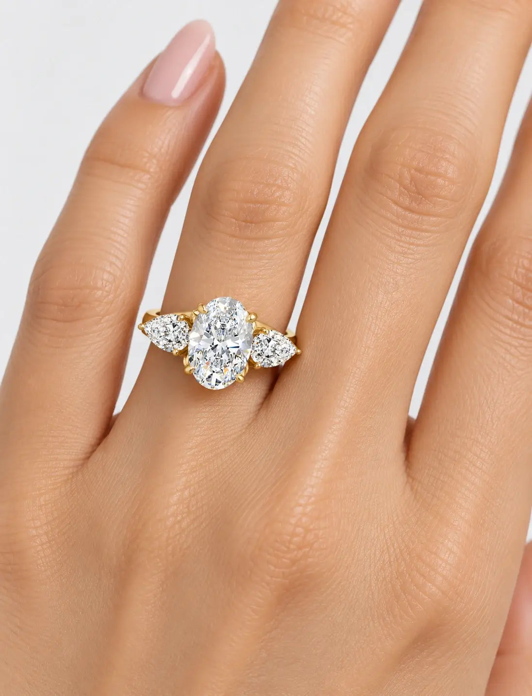 IGI Certified Lab Grown Oval Cut Three-Stone Diamond Engagement Ring with Pear Side Stones in Gold & Platinum