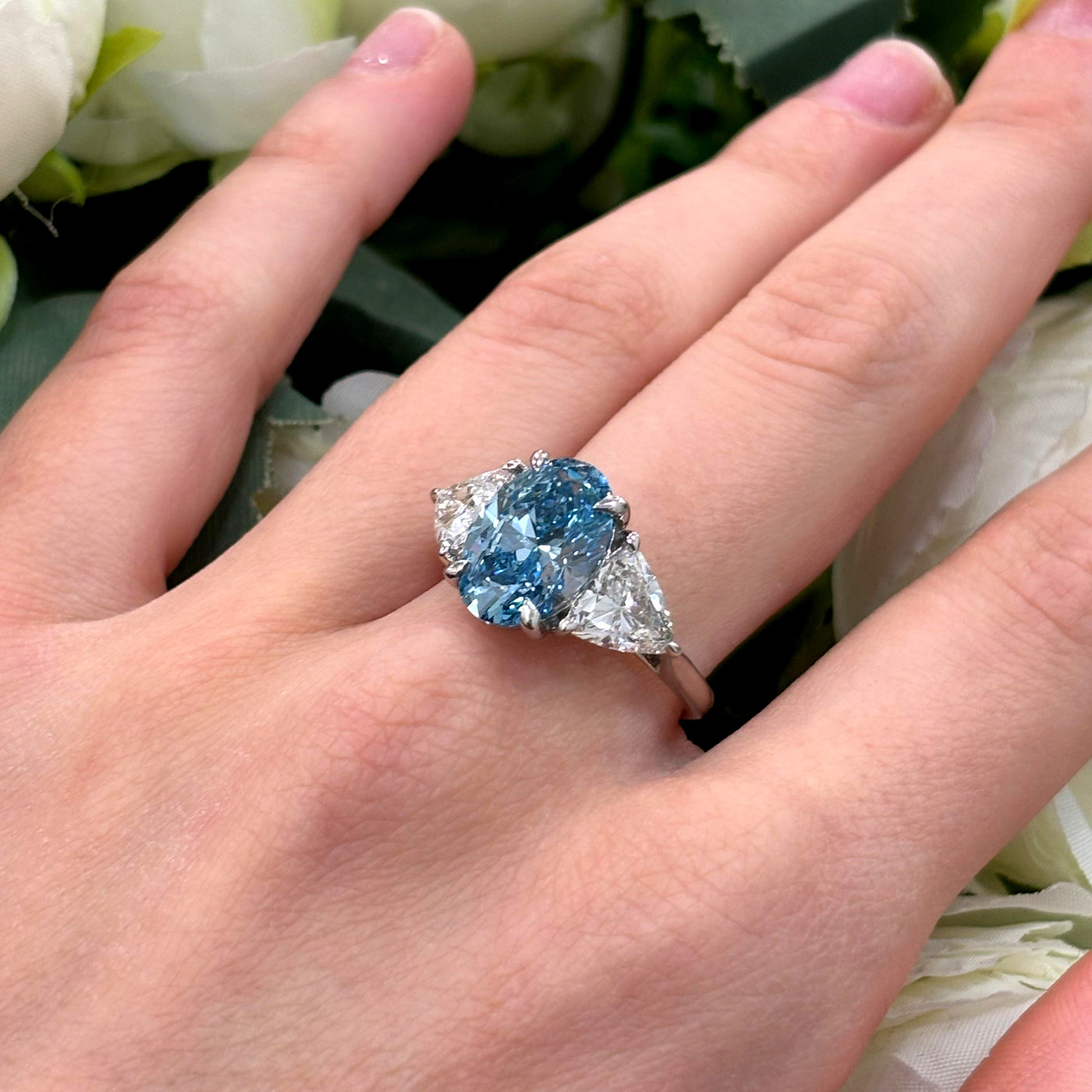 6.05 Carat IGI Lab Fancy Vivid Blue Oval & Side Trillion Diamond Three-Stone Ring In Platinum