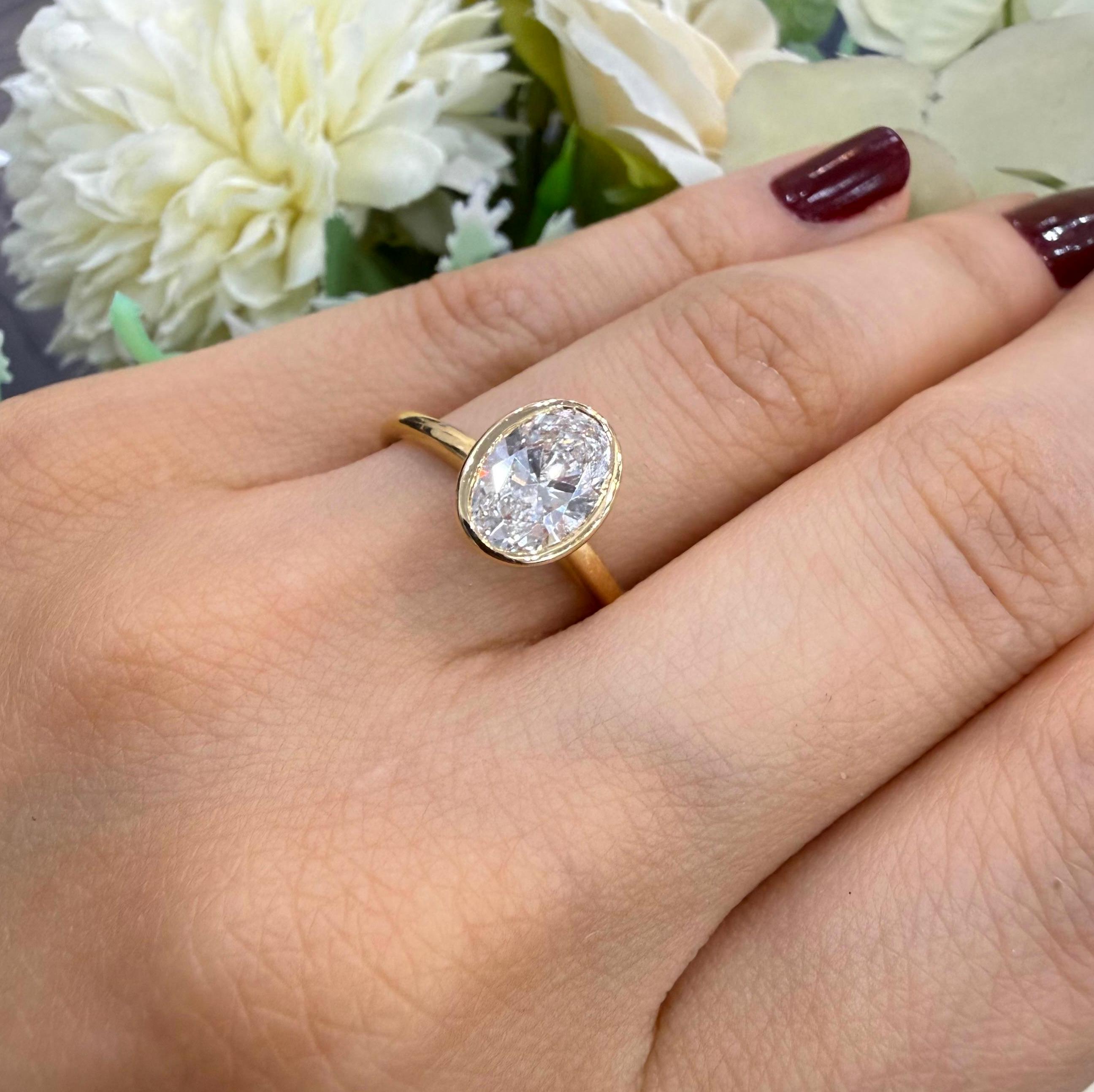 IGI 1.40ct E/VS Oval Lab Diamond Bezel Set Solitaire Ring In 18k Yellow Gold