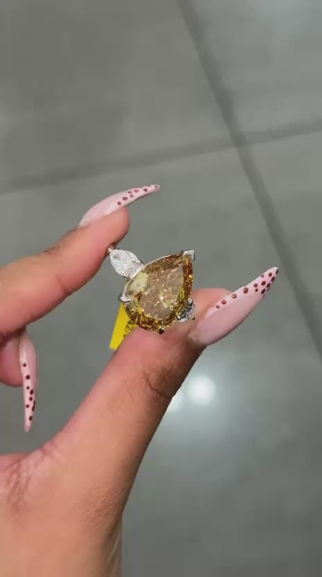 Rare Beauty: Certified 12.50ct Fancy Vivid Brownish Yellow Pear Diamond Trilogy Ring in Platinum