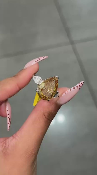 Rare Beauty: Certified 12.50ct Fancy Vivid Brownish Yellow Pear Diamond Trilogy Ring in Platinum